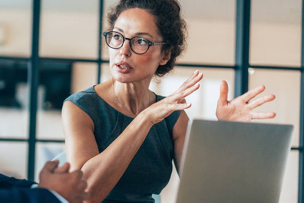 A woman having a consultative conversation about RxIQ Price AI.