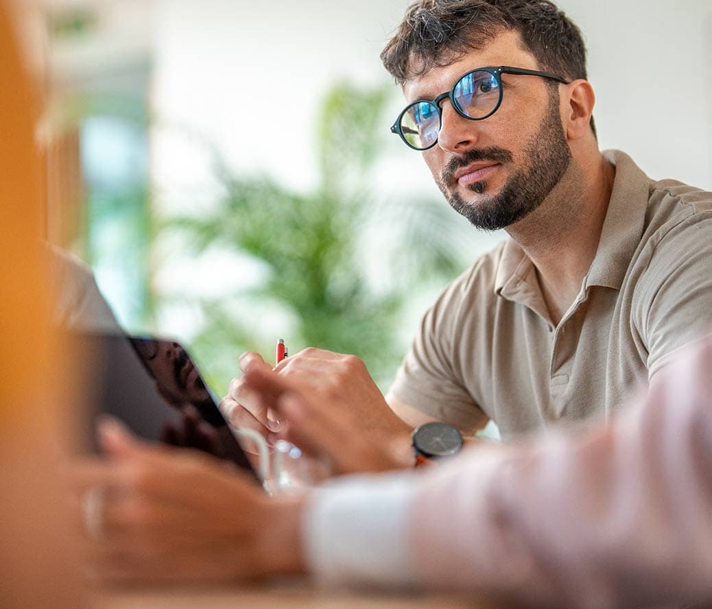 An RxSense employee listens to the client's needs in a consultation about pharmacy benefits.