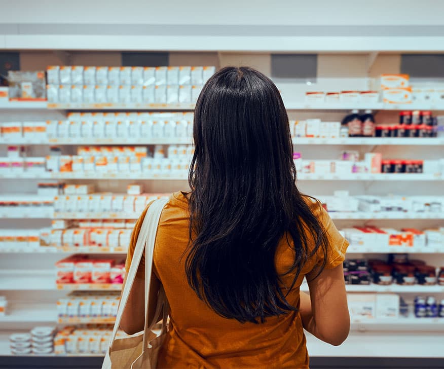A woman contemplating her pharamcy and prescription options.
