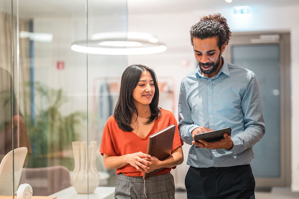 Two workers review the performance of their benefit plan.