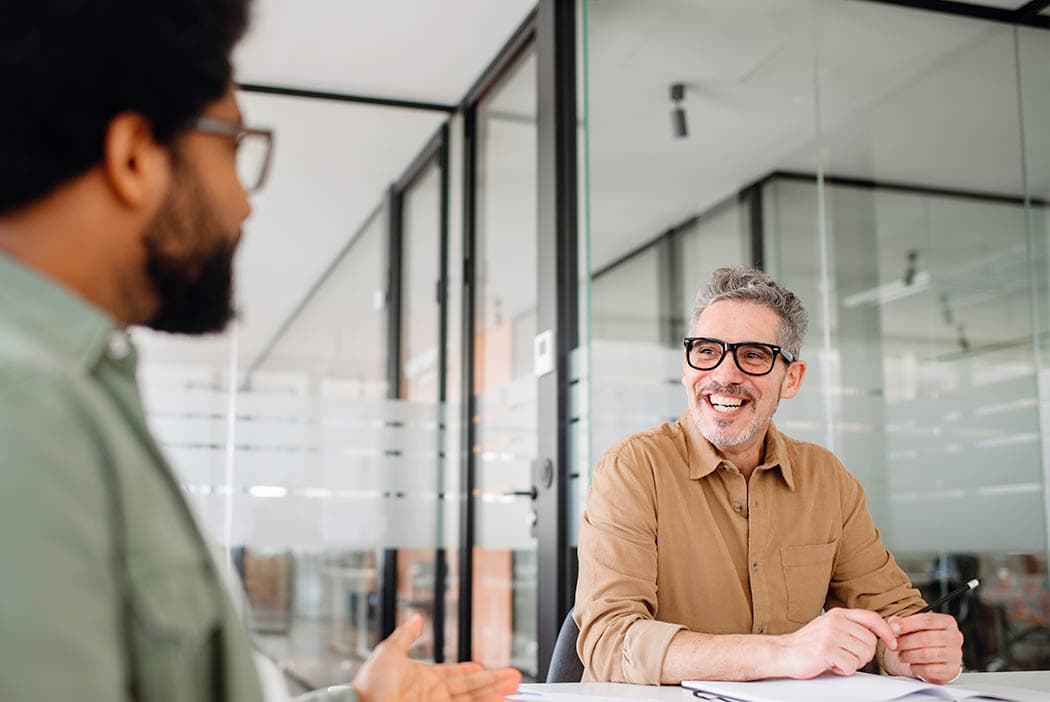 Health plan administrators in a consultative meeting discussing how RxSense can improve pharmacy benefit management and deliver cost-effective healthcare solutions.